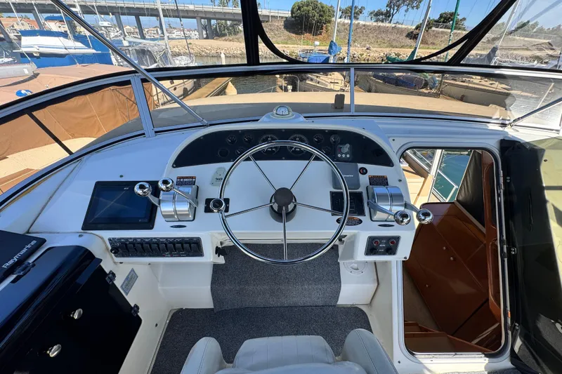 Slide: The Image of Pilothouse of 2006 Meridian 490 yacht with steering wheel, controls, and navigation equipment. - 28