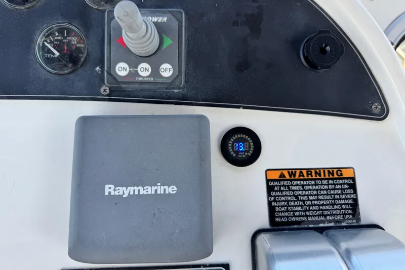 Slide: The Image of Control panel of a 2006 Meridian 490 Pilothouse with Raymarine equipment and warning label. - 32