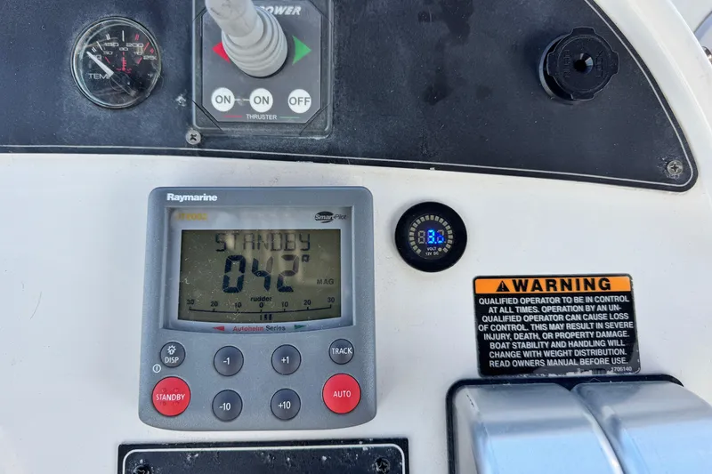 Slide: The Image of Control panel of a 2006 Meridian 490 Pilothouse with Raymarine display and warning label. - 33