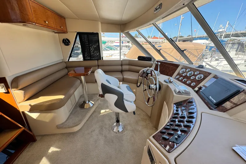 Slide: The Image of 2006 Meridian 490 Pilothouse interior with helm, seating, and navigation equipment. - 36