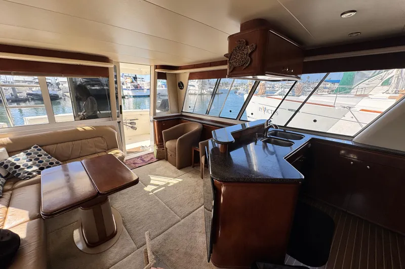 Slide: The Image of Luxurious interior of a 2006 Meridian 490 Pilothouse yacht with elegant furnishings and marina view. - 37