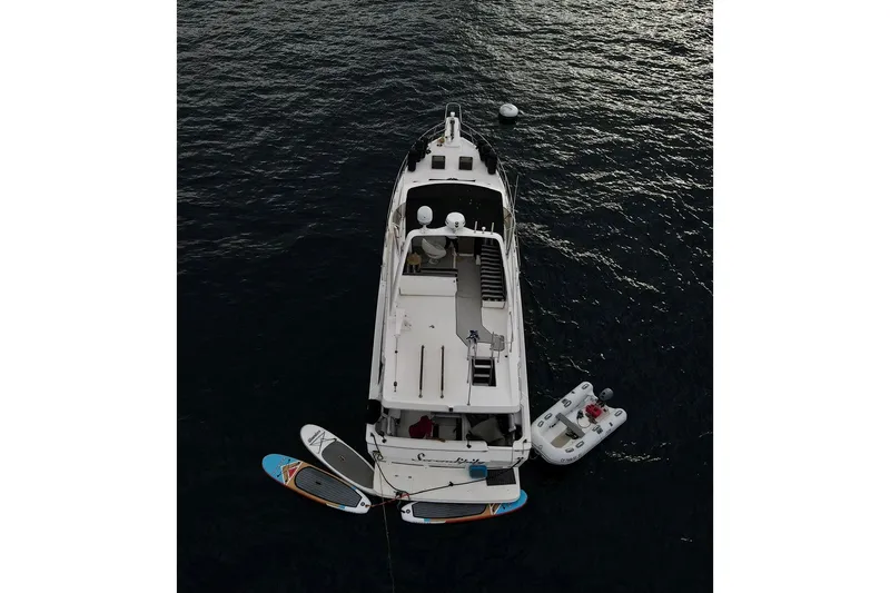 Slide: The Image of Aerial view of 2006 Meridian 490 Pilothouse yacht with paddleboards and dinghy. - 44