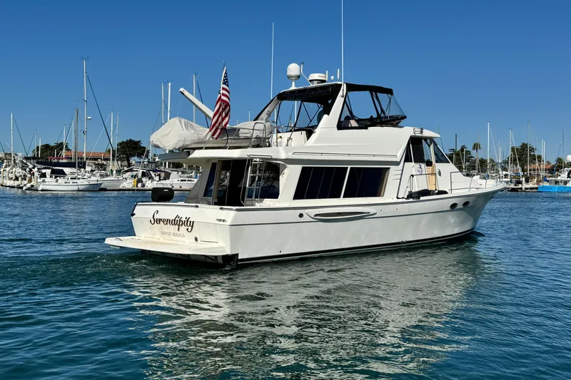 Slide: The Image of 2006 Meridian 490 Pilothouse yacht named "Serendipity" in a marina setting. - 5
