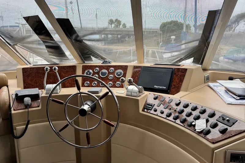 Slide: The Image of Pilothouse interior of 2006 Meridian 490, featuring steering wheel and control panel. - 7