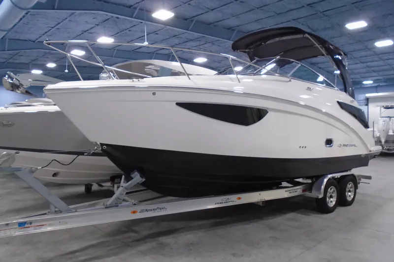 The Image of 2026 Regal 26 XO boat on trailer in indoor showroom. - 0