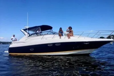 Slide: The Image of 2005 Regal Commodore 3560 IO yacht on water with people enjoying the sun. - 1