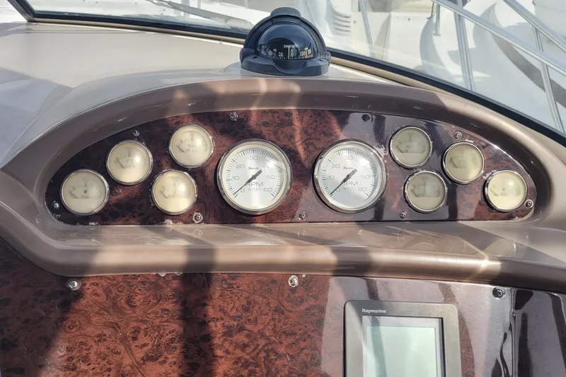 Slide: The Image of Dashboard of a 2005 Regal Commodore 3560 IO boat with gauges and compass. - 13