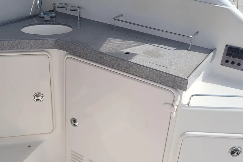 Slide: The Image of 2005 Regal Commodore 3560 IO boat kitchenette with sink and storage cabinets. - 15