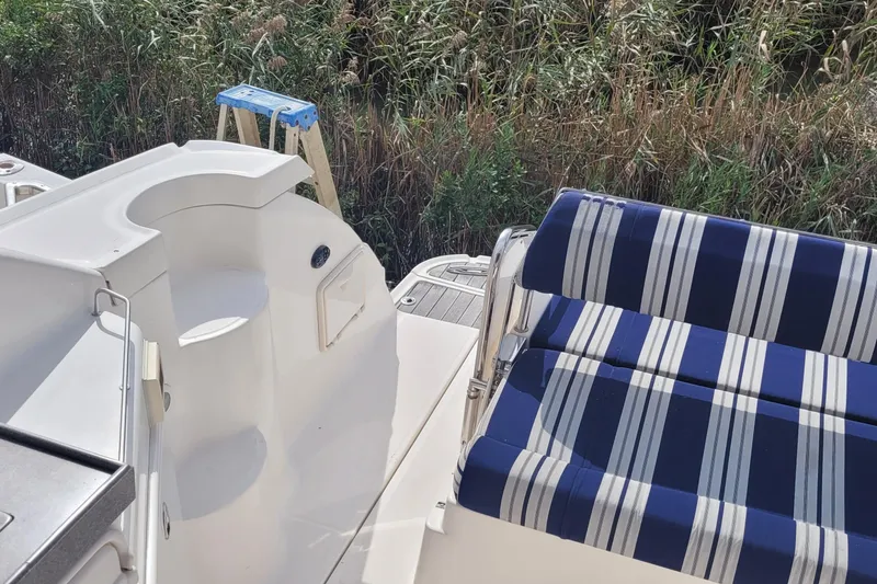 Slide: The Image of 2005 Regal Commodore 3560 IO boat interior with striped seating and outdoor view. - 17