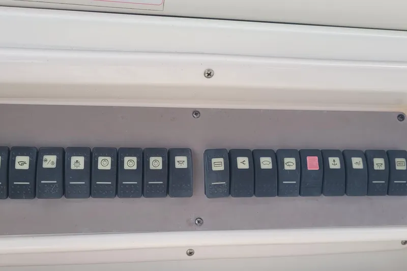 Slide: The Image of Control panel of a 2005 Regal Commodore 3560 IO boat with labeled switches. - 18
