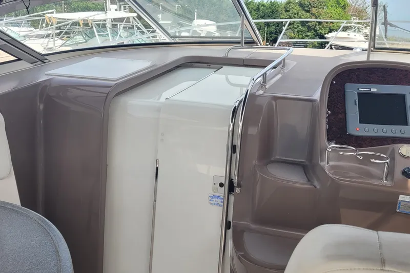 Slide: The Image of 2005 Regal Commodore 3560 IO helm with navigation display and seating area. - 21