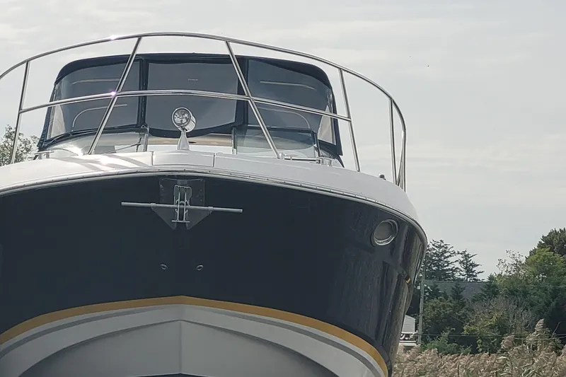 Slide: The Image of 2005 Regal Commodore 3560 IO boat, front view with railing and spotlight. - 3