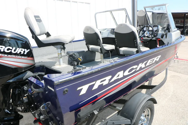Slide: The Image of 2019 Tracker Pro Guide V-16 WT boat with Mercury FourStroke engine, parked on trailer. - 13