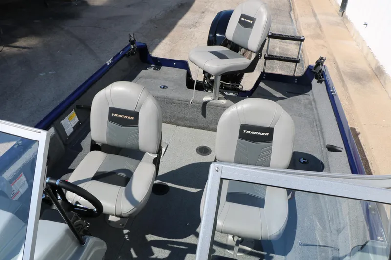 Slide: The Image of 2019 Tracker Pro Guide V-16 WT boat interior with three gray seats. - 17