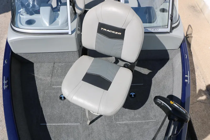 Slide: The Image of 2019 Tracker Pro Guide V-16 WT boat interior with seating and Minn Kota motor. - 19