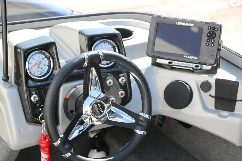 Slide: The Image of 2019 Tracker Pro Guide V-16 WT dashboard with steering wheel and Lowrance fishfinder. - 24