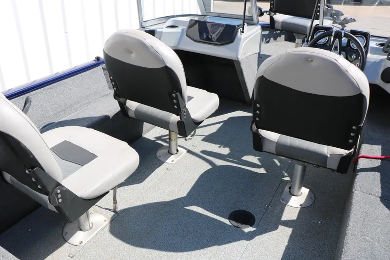 Slide: The Image of 2019 Tracker Pro Guide V-16 WT boat interior with gray seating and steering console. - 26