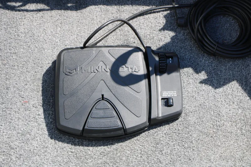 Slide: The Image of Minn Kota foot pedal on 2019 Tracker Pro Guide V-16 WT boat carpet. - 34