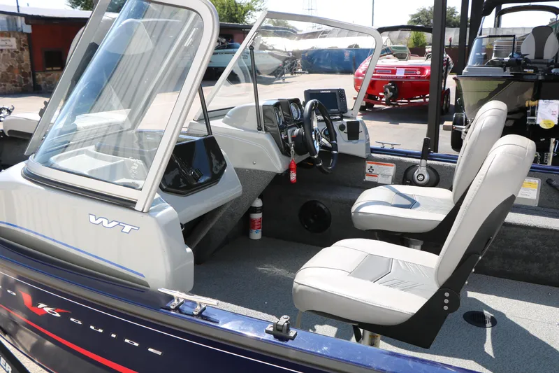 Slide: The Image of 2019 Tracker Pro Guide V-16 WT boat interior with seating and dashboard. - 40