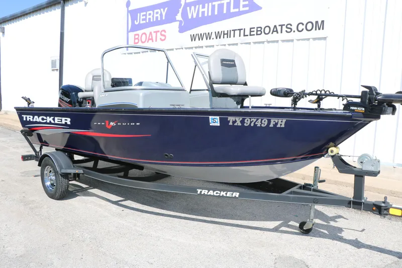 Slide: The Image of 2019 Tracker Pro Guide V-16 WT boat on trailer, parked outside dealership. - 6