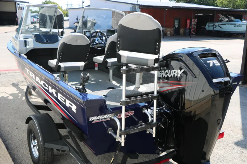 Slide: The Image of 2019 Tracker Pro Guide V-16 WT boat with Mercury 75 engine, parked outdoors. - 9