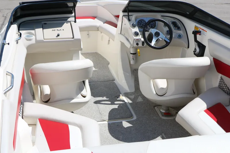 Slide: The Image of Interior of a 2006 Larson 206 Senza boat with white and red seating. - 10