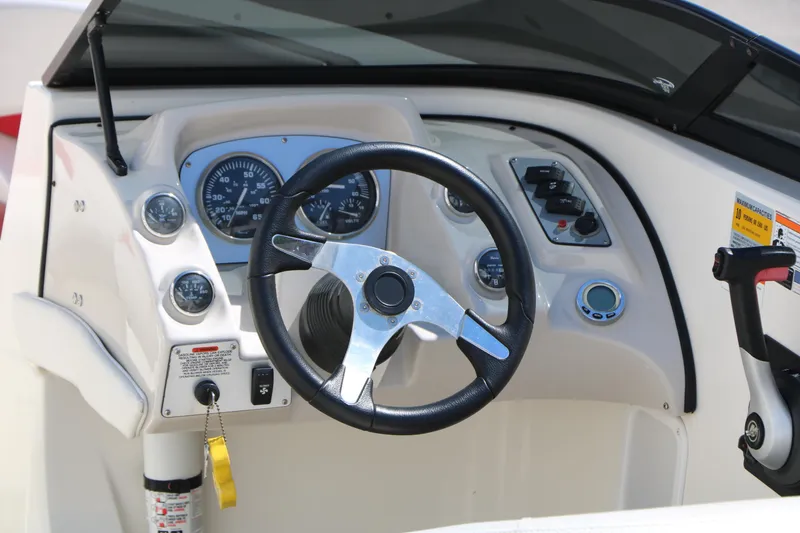 Slide: The Image of 2006 Larson 206 Senza boat dashboard with steering wheel and instrument panel. - 11