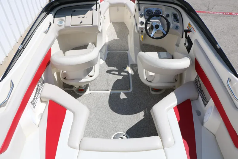 Slide: The Image of Interior of 2006 Larson 206 Senza boat with red and white seating and steering wheel. - 12
