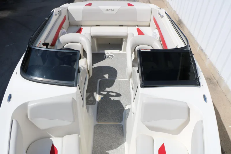 Slide: The Image of 2006 Larson 206 Senza boat interior with white and red seating, dual consoles, and open bow. - 14