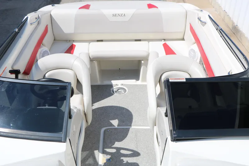 Slide: The Image of 2006 Larson 206 Senza boat interior with white and red seating, dual windshields. - 16