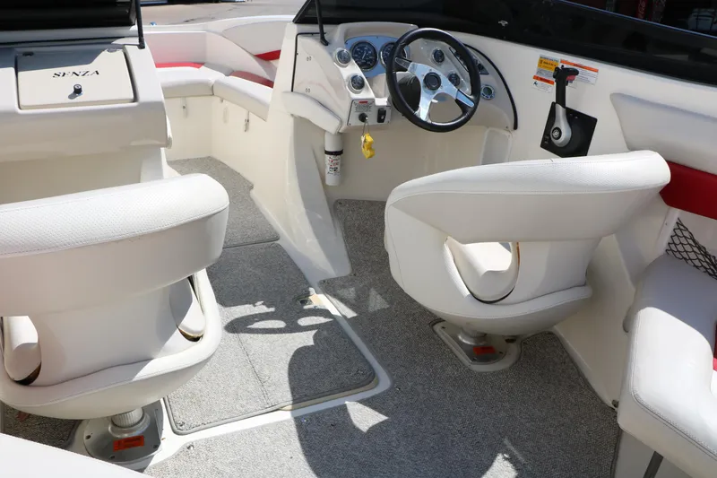 Slide: The Image of Interior of a 2006 Larson 206 Senza boat with white seating and steering wheel. - 20