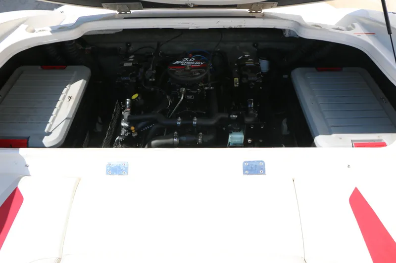 Slide: The Image of Engine compartment of a 2006 Larson 206 Senza boat, featuring a 5.0 Mercury engine. - 21