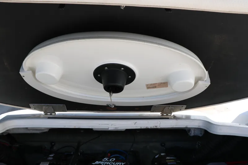 Slide: The Image of Engine compartment of a 2006 Larson 206 Senza boat with visible components. - 24