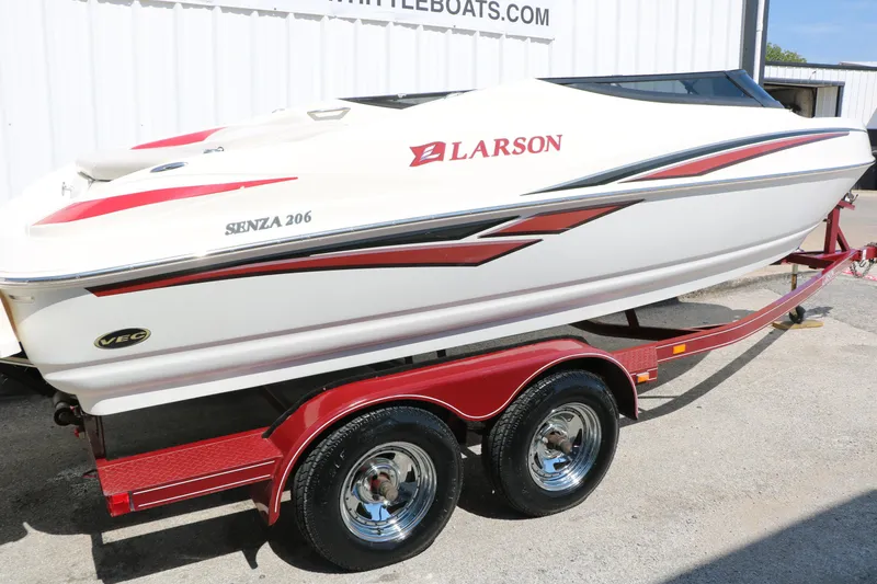 Slide: The Image of 2006 Larson 206 Senza boat on red trailer, white and red design. - 29