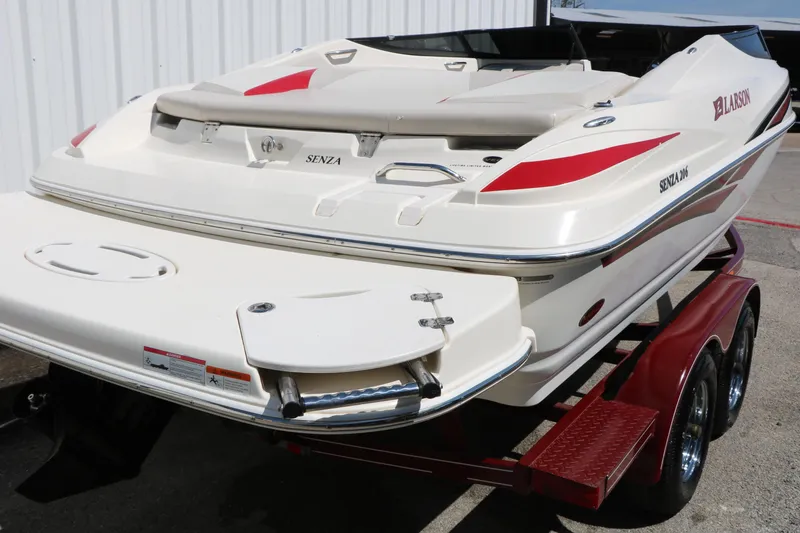 Slide: The Image of 2006 Larson 206 Senza boat on trailer, white with red accents, rear view. - 3
