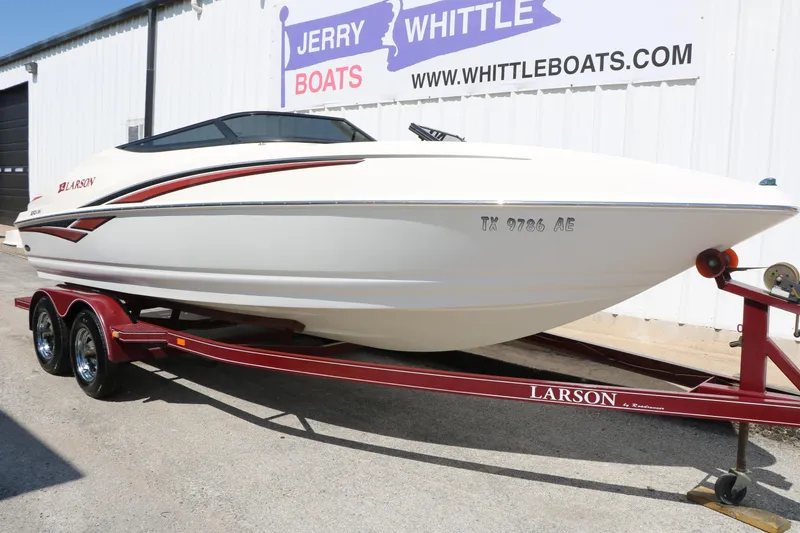 Slide: The Image of 2006 Larson 206 Senza boat on trailer at dealership, Jerry Whittle Boats. - 4