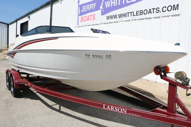 Slide: The Image of 2006 Larson 206 Senza boat on red trailer at Whittle Boats dealership. - 5