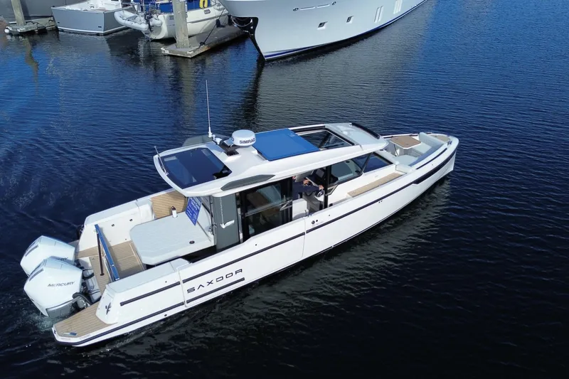 The Image of 2026 Saxdor 340 GTWA boat cruising in a marina, showcasing sleek design and modern features. - 0