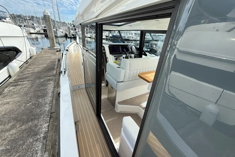 Slide: The Image of 2026 Saxdor 340 GTWA yacht for sale at marina, featuring spacious deck and seating. - 10