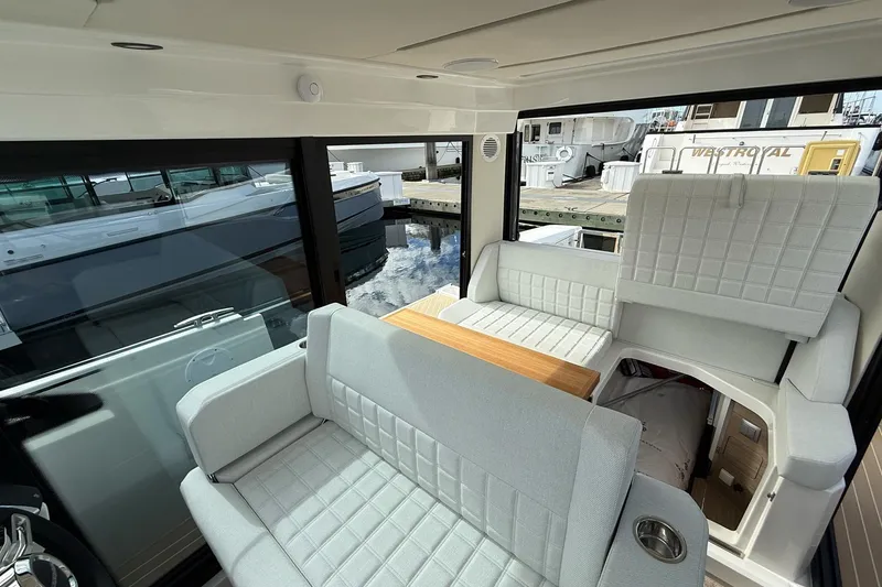 Slide: The Image of Saxdor 340 GTWA 2026 yacht docked at marina, viewed from cabin interior. - 14