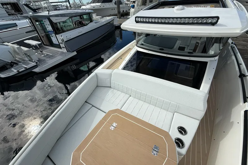 Slide: The Image of 2026 Saxdor 340 GTWA boat with elegant seating and table at a marina. - 18