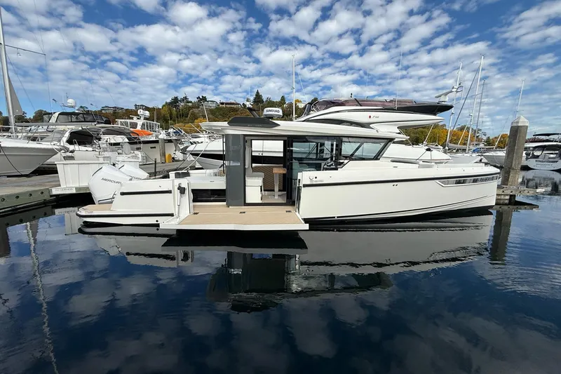 Slide: The Image of 2026 Saxdor 340 GTWA boat docked, featuring sleek design and twin Mercury engines. - 2