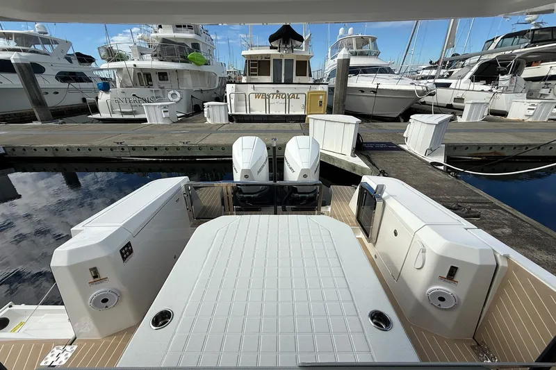 Slide: The Image of 2026 Saxdor 340 GTWA boat docked at marina with twin outboard engines. - 22