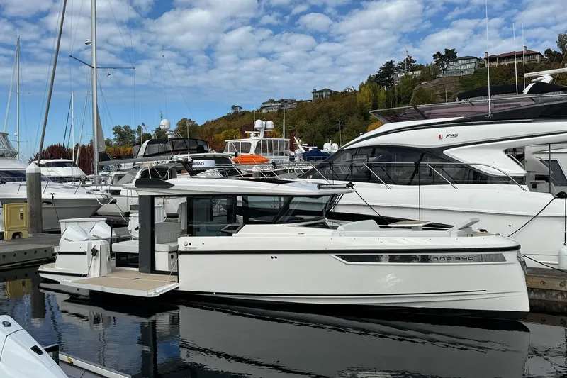 Slide: The Image of 2026 Saxdor 340 GTWA boat docked in a marina under a partly cloudy sky. - 3