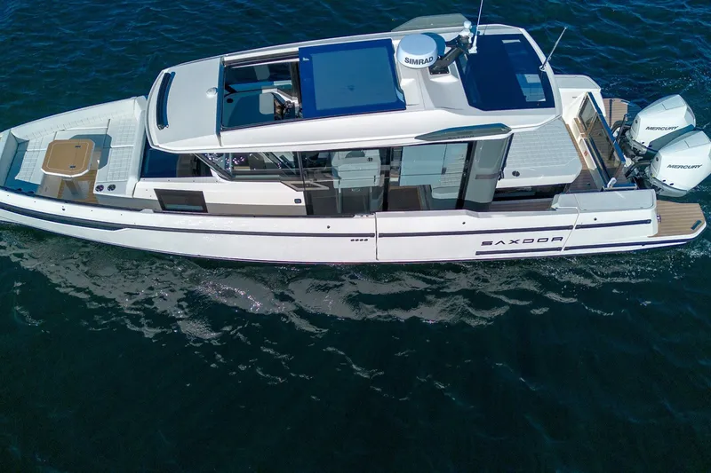 Slide: The Image of 2026 Saxdor 340 GTWA boat cruising on open water, showcasing sleek design and twin engines. - 4