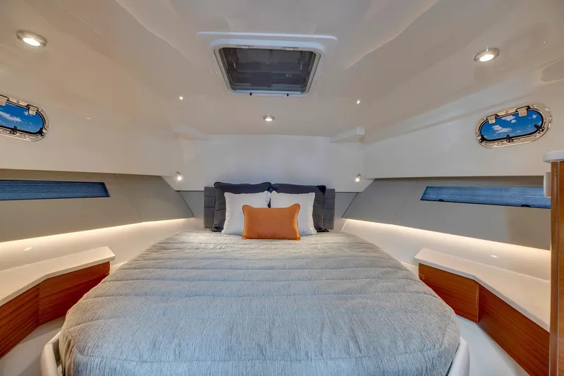 Slide: The Image of Manufacturer Provided Image: Luxurious cabin interior of 2025 Pursuit OS 445 Offshore yacht with cozy bedding. - 20