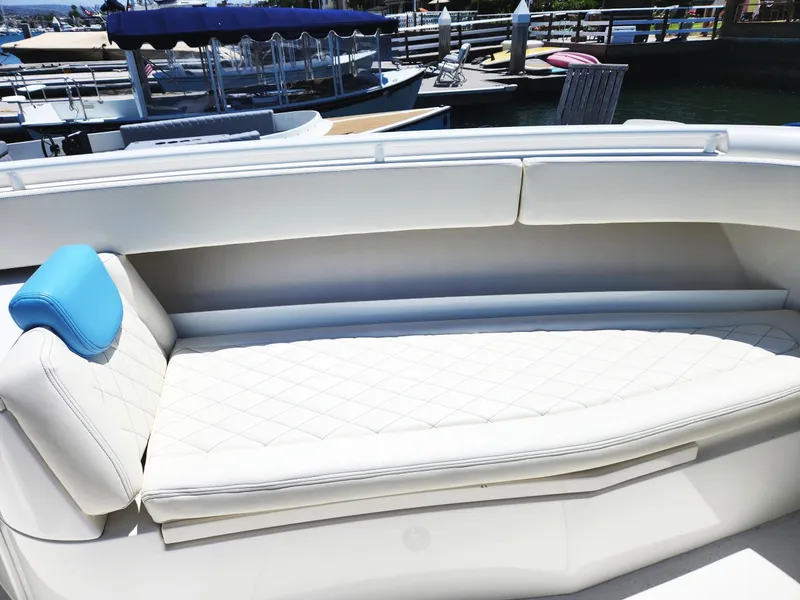 Slide: The Image of 2018 HCB 39 Speciale boat with white quilted seating and blue headrest at a marina. - 31