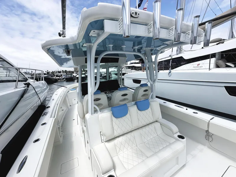 Slide: The Image of HCB 39 Speciale 2018 boat with luxurious seating and sleek design at a marina. - 8