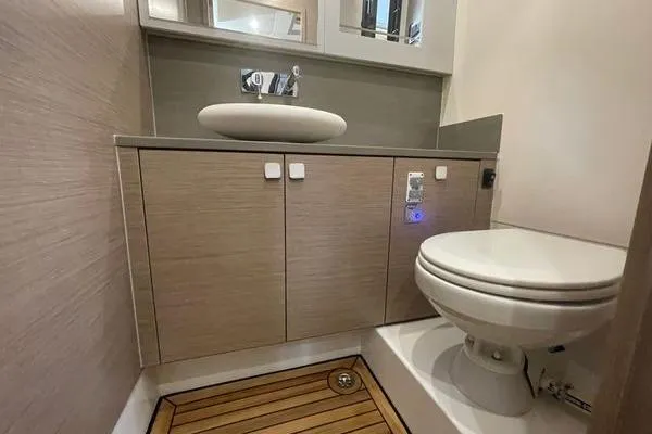 Slide: The Image of 2023 Fjord 38 Xpress bathroom with modern sink, toilet, and wooden flooring. - 18