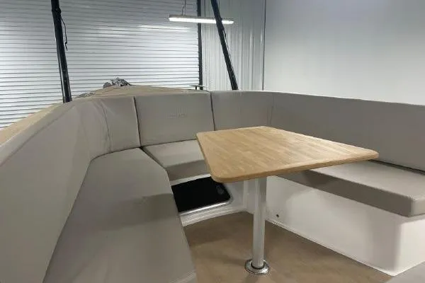 Slide: The Image of 2023 Fjord 38 Xpress interior with beige seating and wooden table in a modern design. - 20